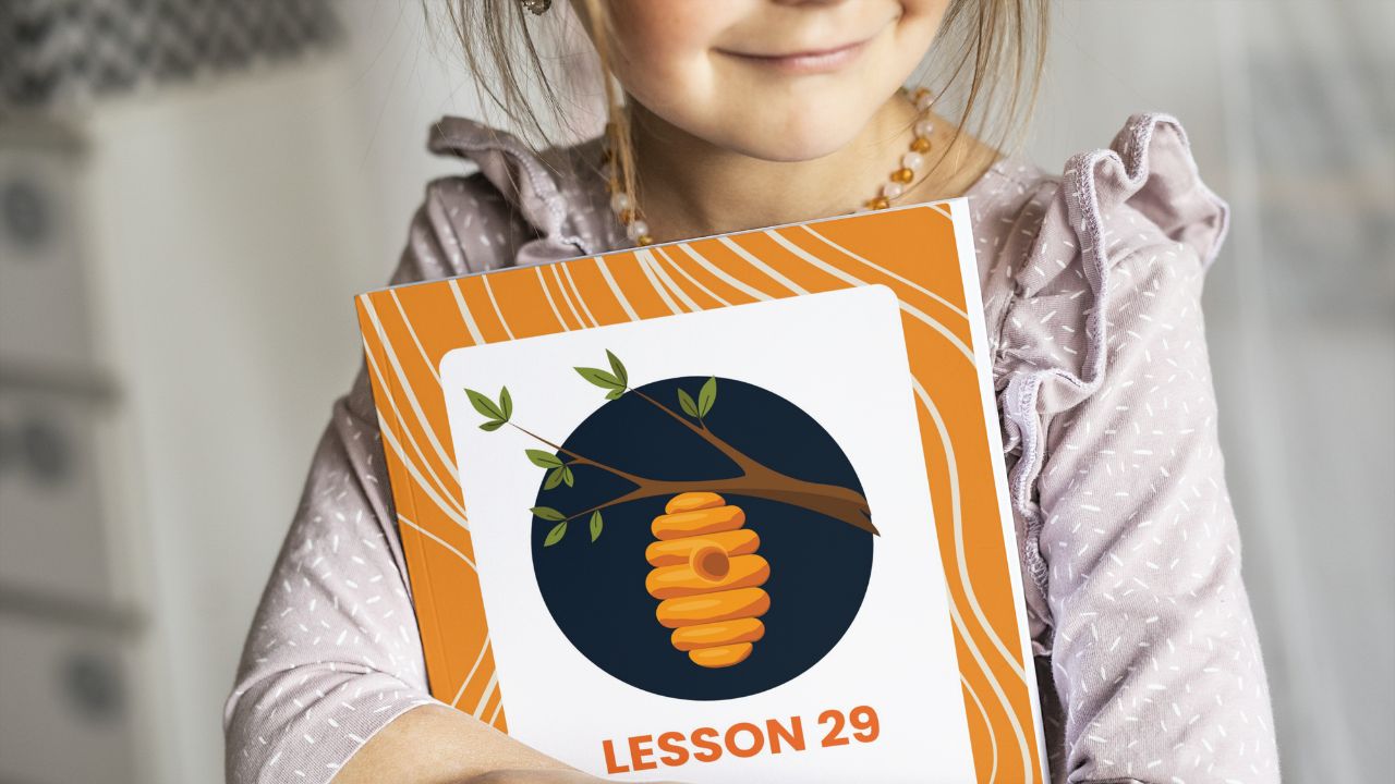 A child holding the curriculum workbook